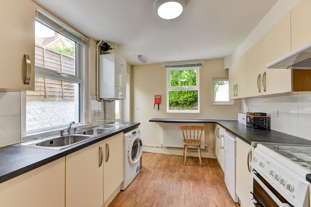 Bright galley kitchen with ample counter space,...