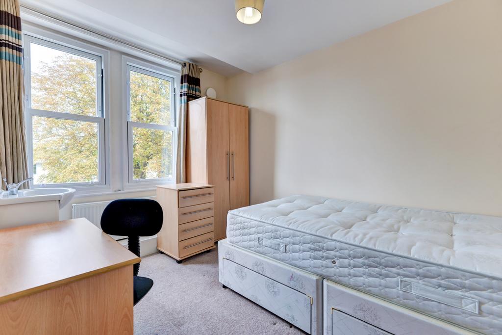 Bright, neatly presented bedroom with a large d...