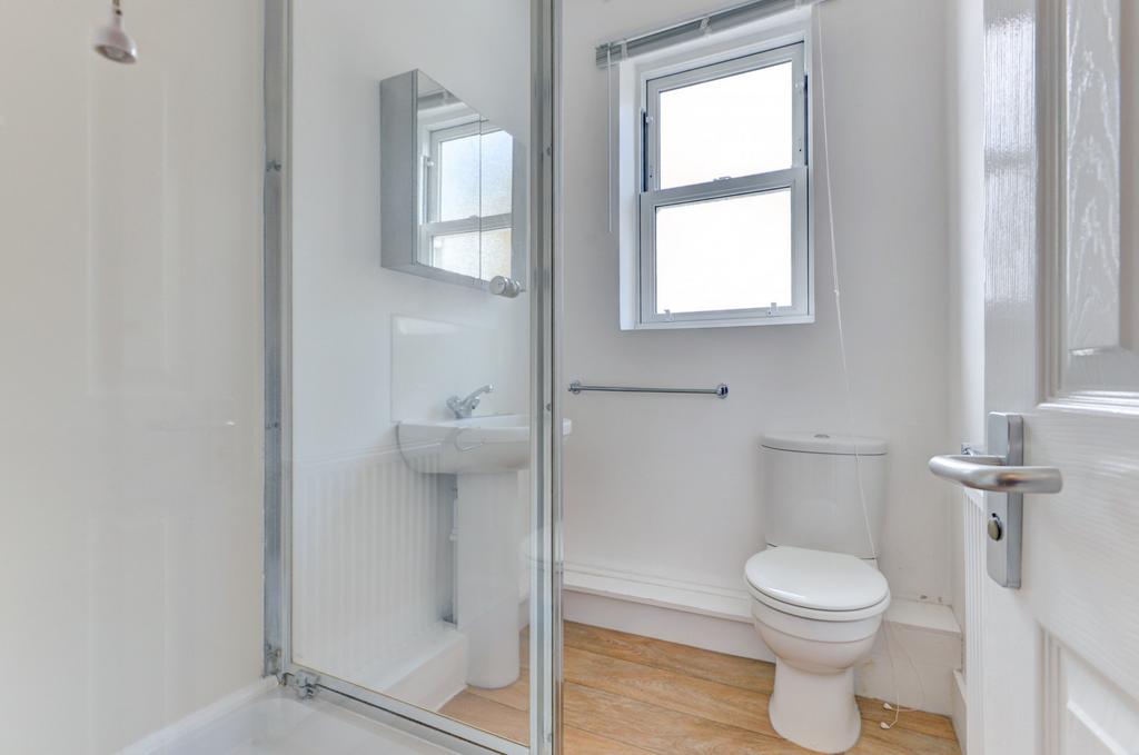 Bright, modern bathroom with a walk-in shower, ...