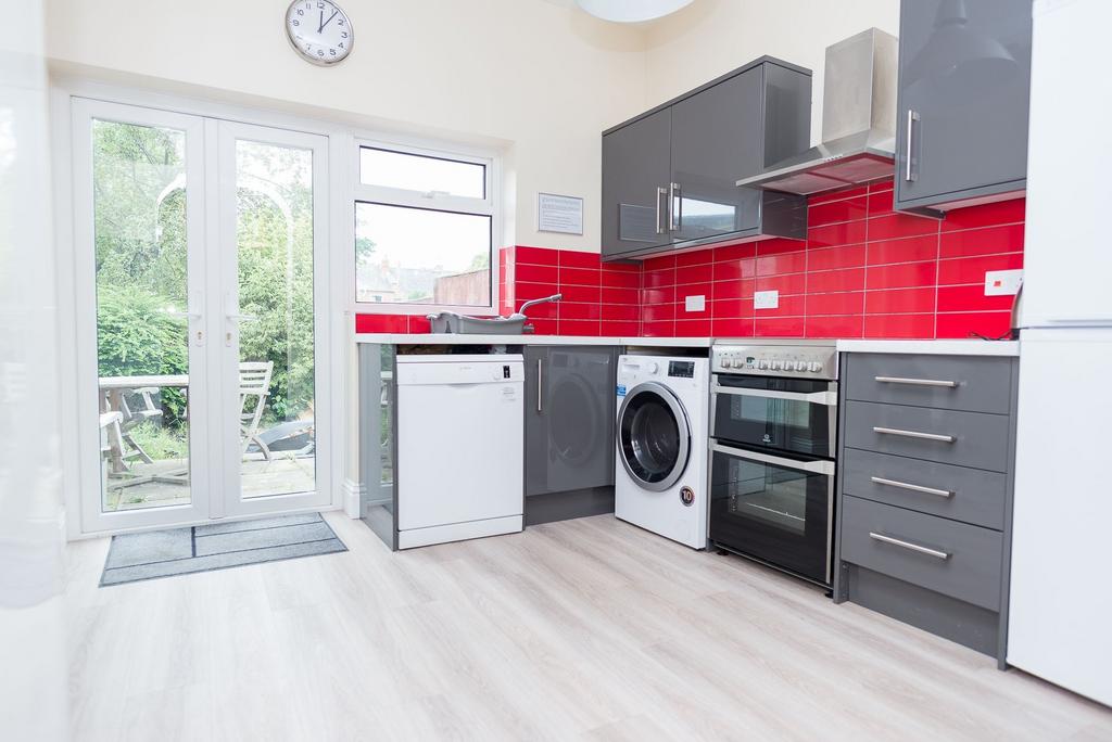 Bright modern kitchen with glossy grey cabinets...