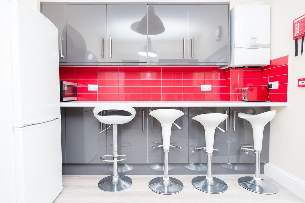 Bright modern kitchen with glossy grey cabinets...