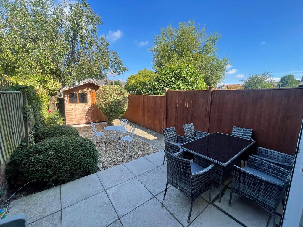 Sunny private garden with paved patio and dinin...