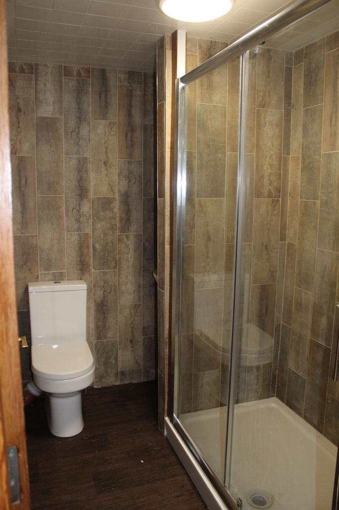 A modern bathroom featuring a shower enclosure ...