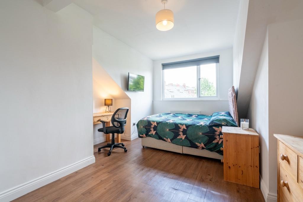 Bright and welcoming bedroom featuring a comfor...