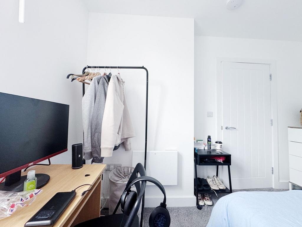 Bright, tidy bedroom with neutral dÃ©cor...