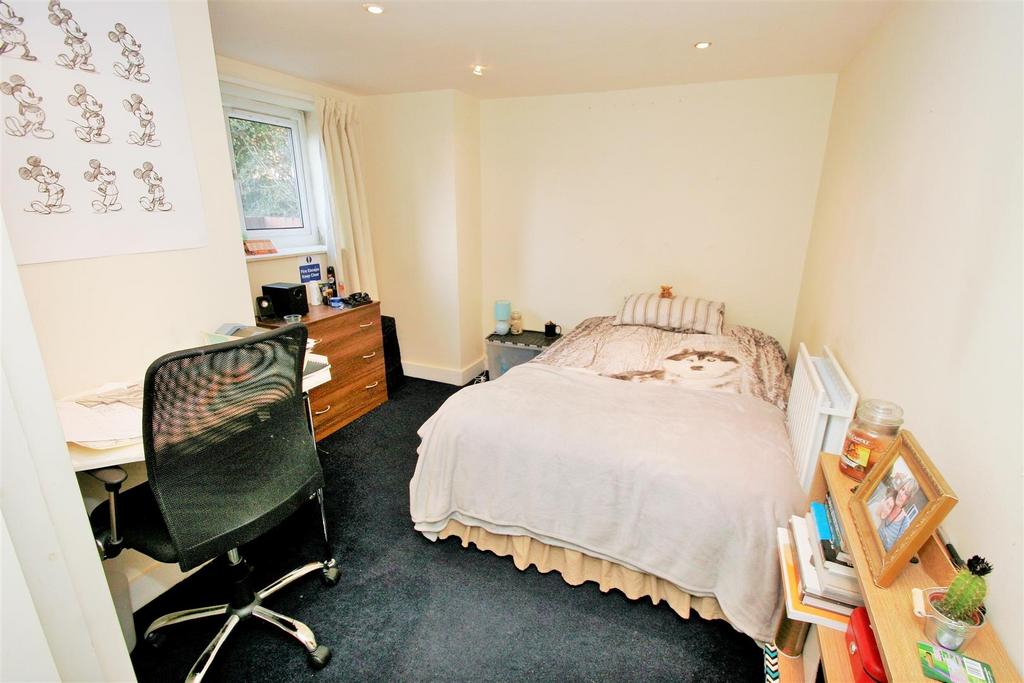 A cozy bedroom featuring a bed with a wolf prin...