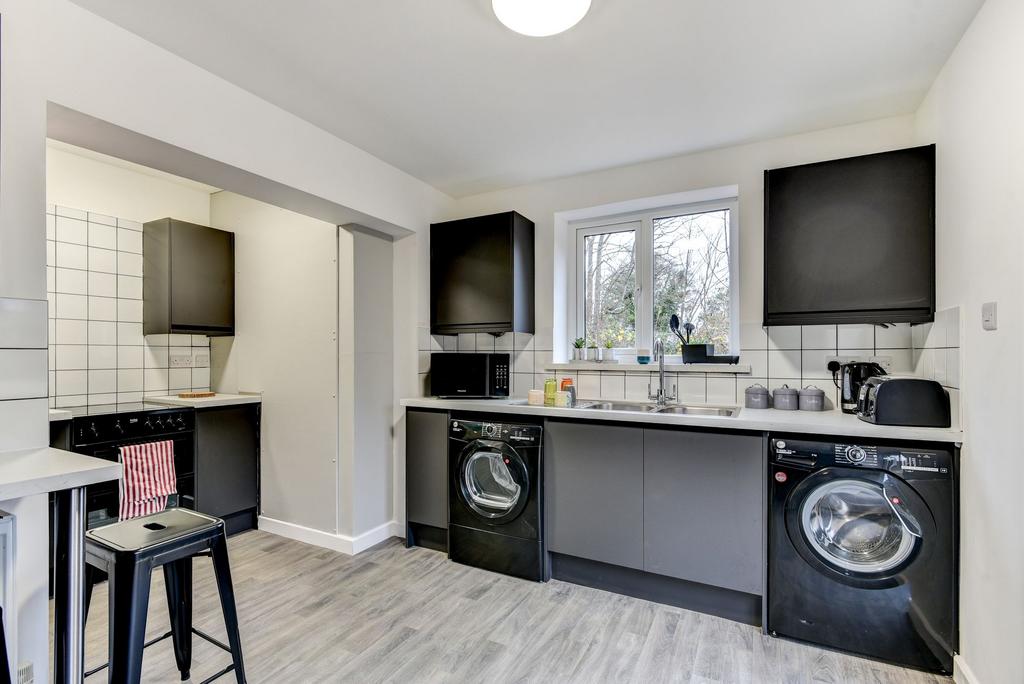 Modern kitchen featuring sleek cabinetry, ample...