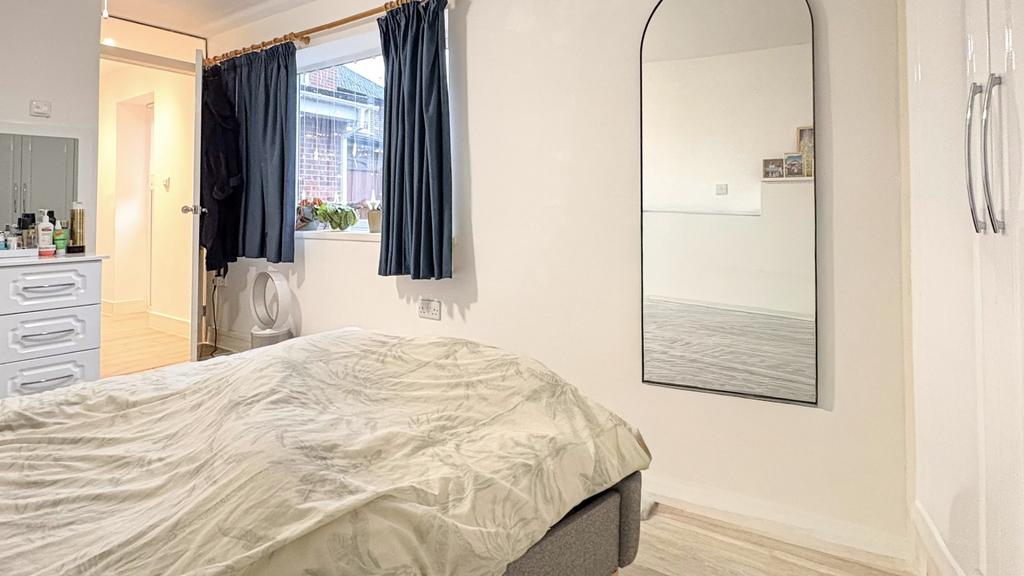 Bright, simply styled bedroom with a comfortabl...