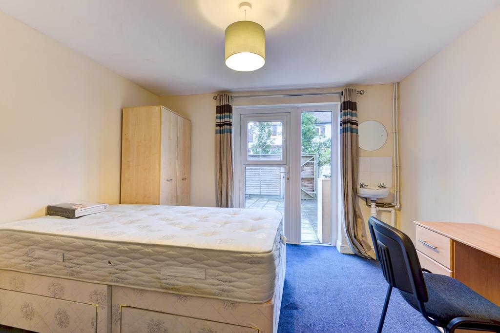 A bright and spacious master bedroom featuring ...