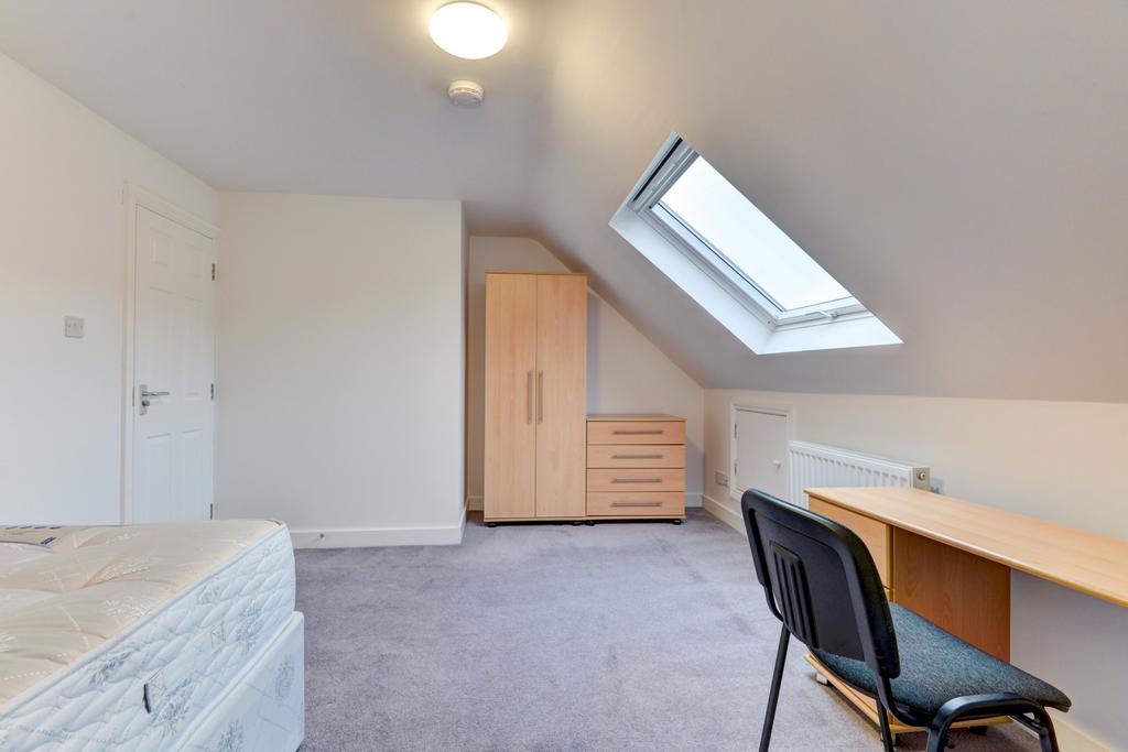 Bright upstairs double bedroom with a sloped ce...
