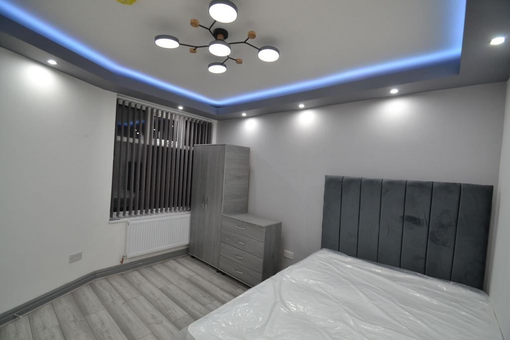 Modern and stylish bedroom featuring a large he...