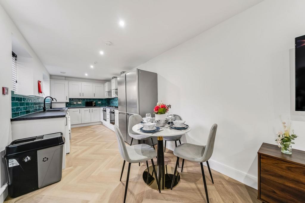 Modern and bright kitchen with white cabinets, ...