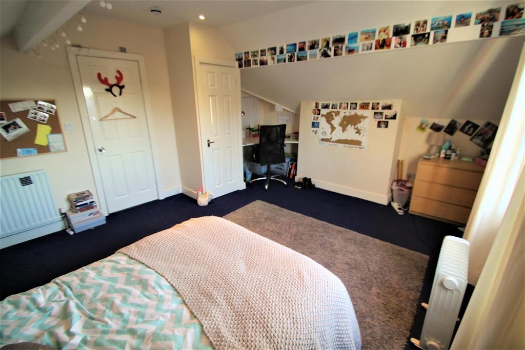 Bright and welcoming bedroom featuring a neatly...