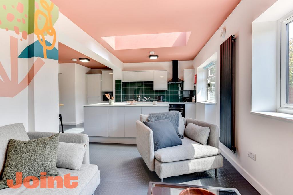 Bright, modern open-plan living space with a co...