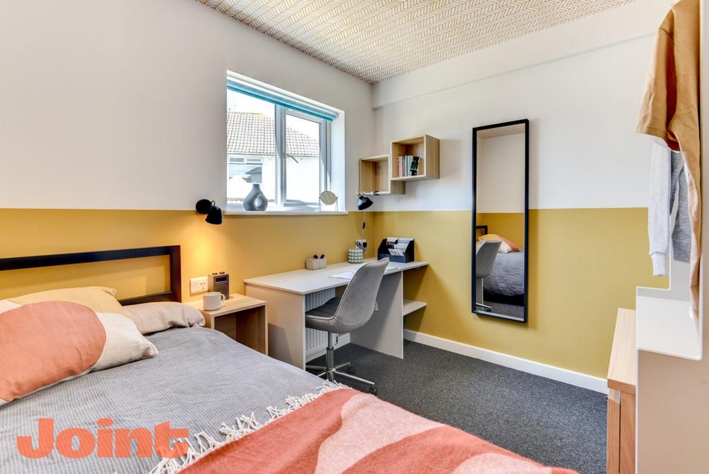 Bright, modern student bedroom with a comfortab...