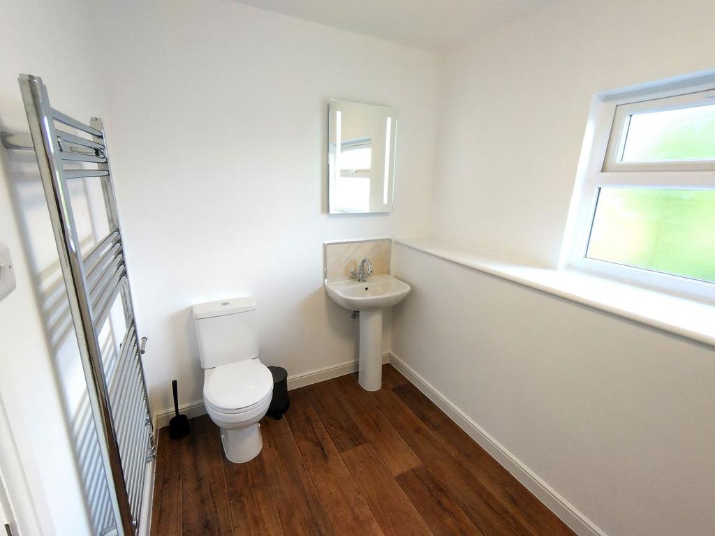 Bright, modern bathroom with a white toilet and...