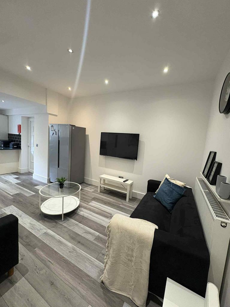 Modern and inviting living room featuring a sle...