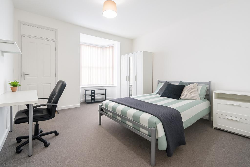 A bright and modern bedroom featuring a double ...