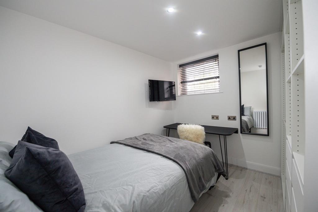 Bright and modern double bedroom featuring a co...
