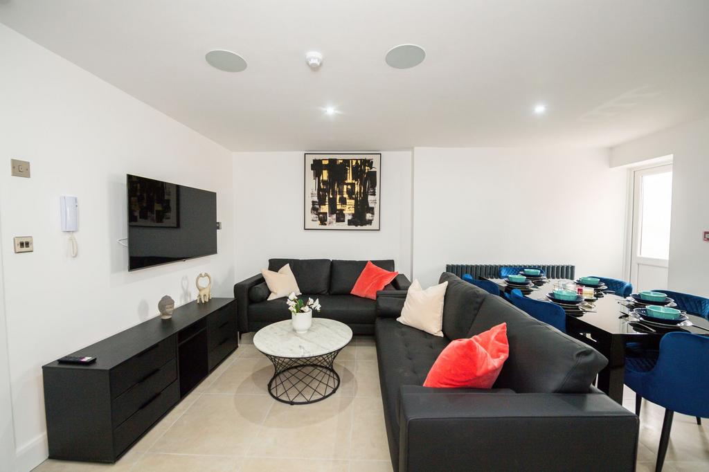 Modern and spacious living room with sleek blac...