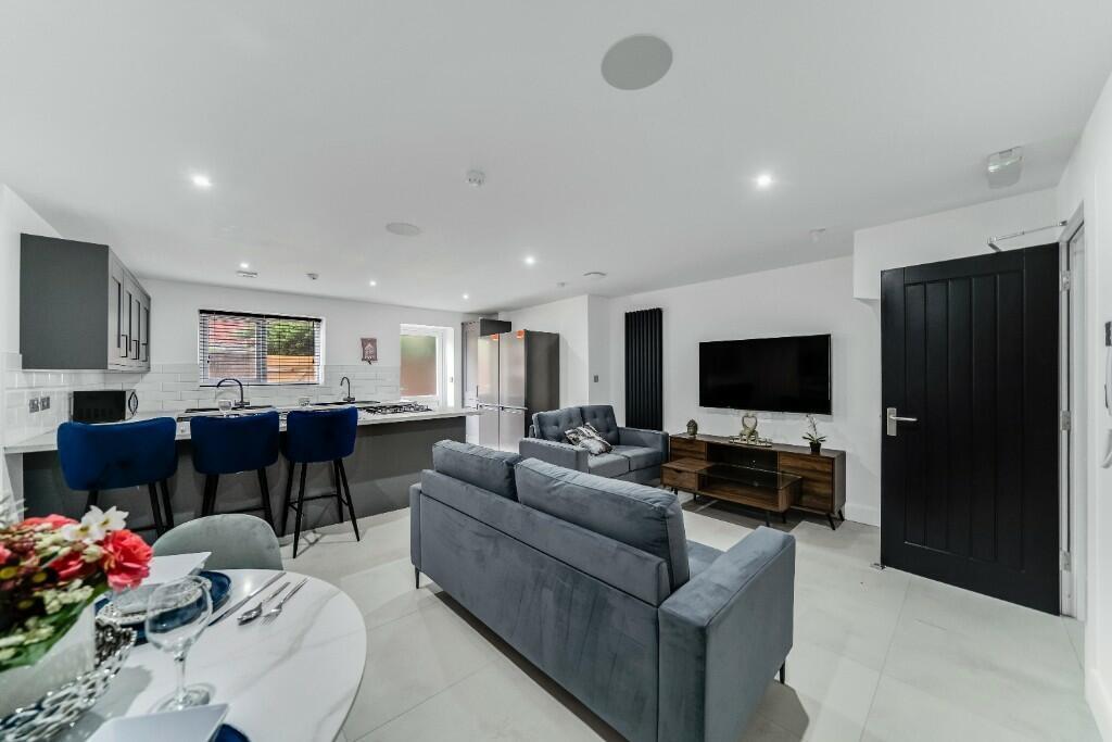 A spacious and modern living room featuring amp...