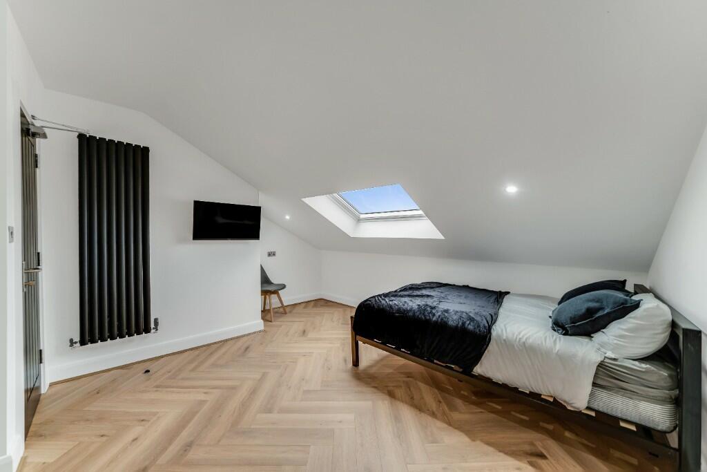 Bright and modern bedroom featuring a comfortab...
