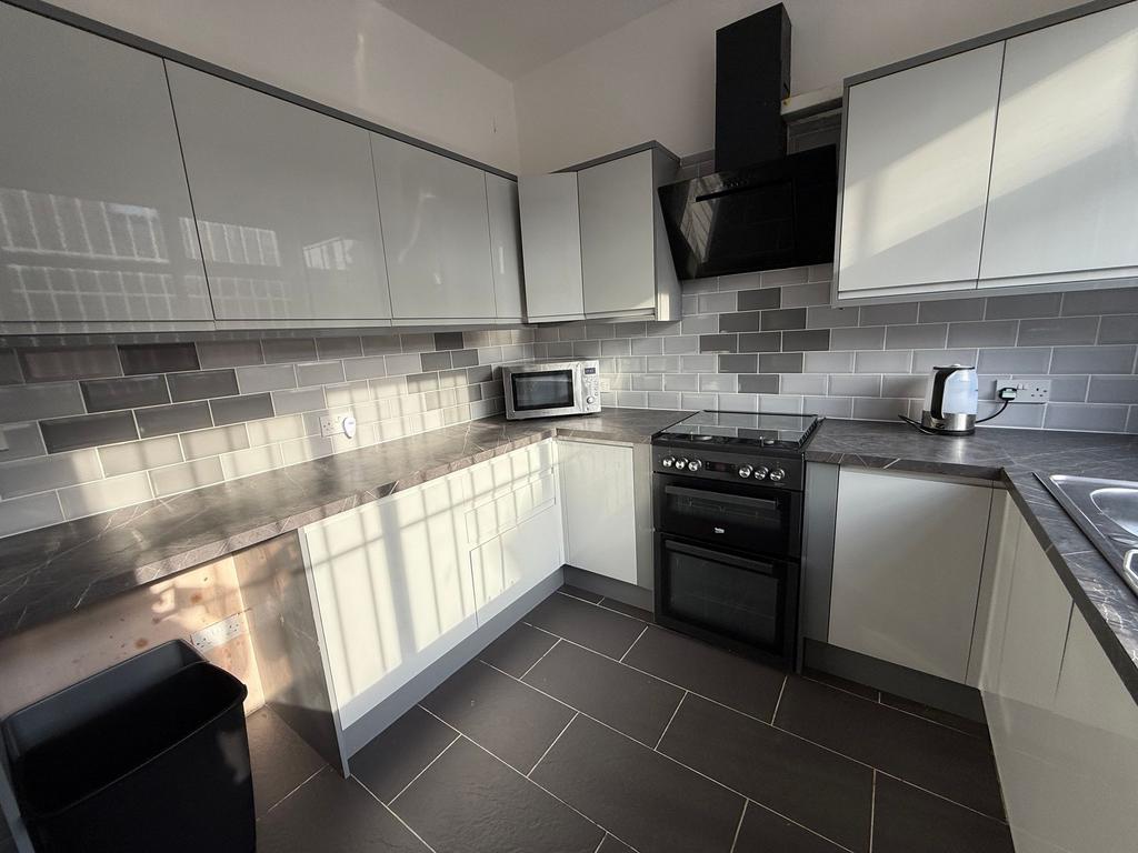 Bright, modern kitchen with sleek glossy cabine...