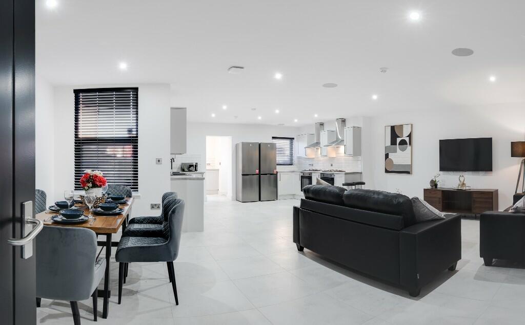 A spacious and modern living room with bright, ...