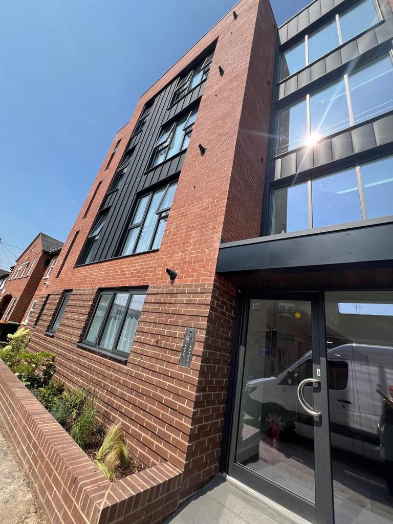 Contemporary brick and metal-fronted building w...