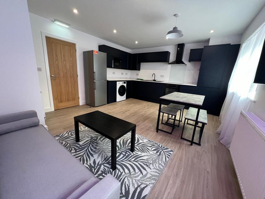 Bright open-plan living area with a modern fitt...