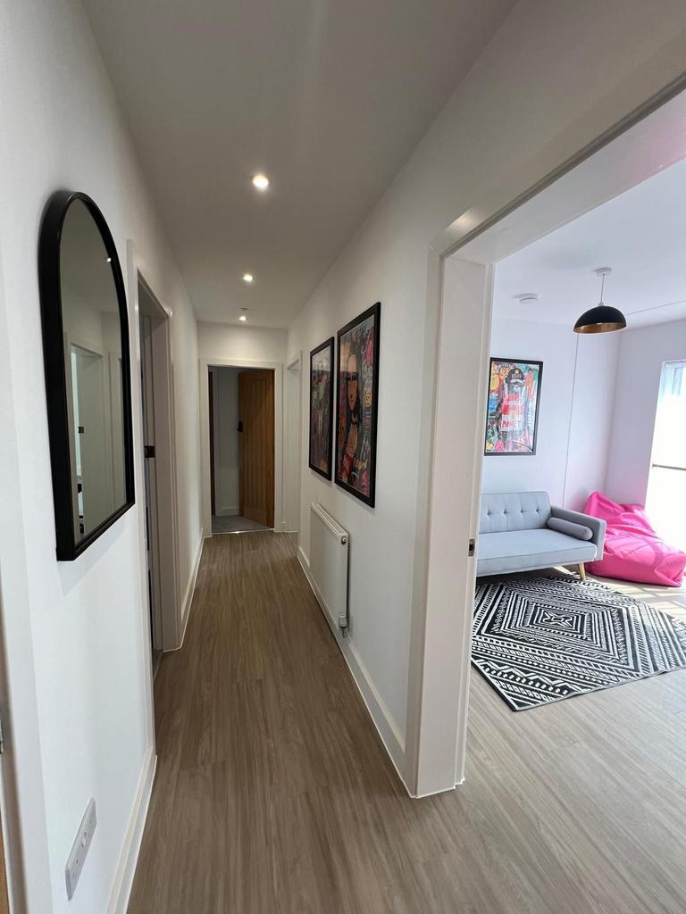 Bright, modern hallway with wood-effect floorin...