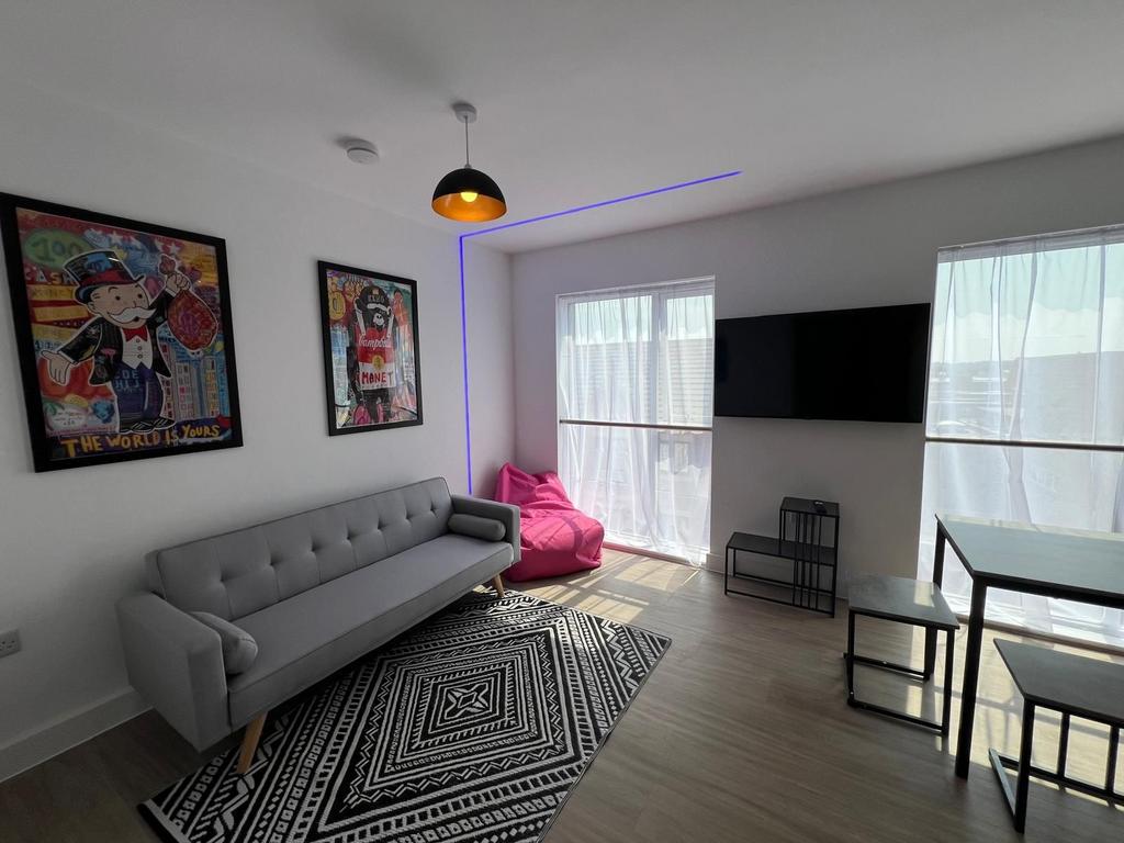 Bright, modern living room with large windows, ...