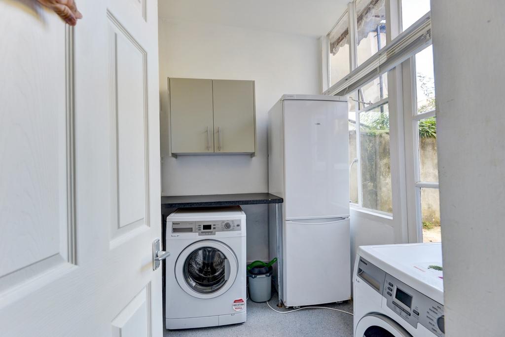Bright and tidy kitchen area with modern applia...