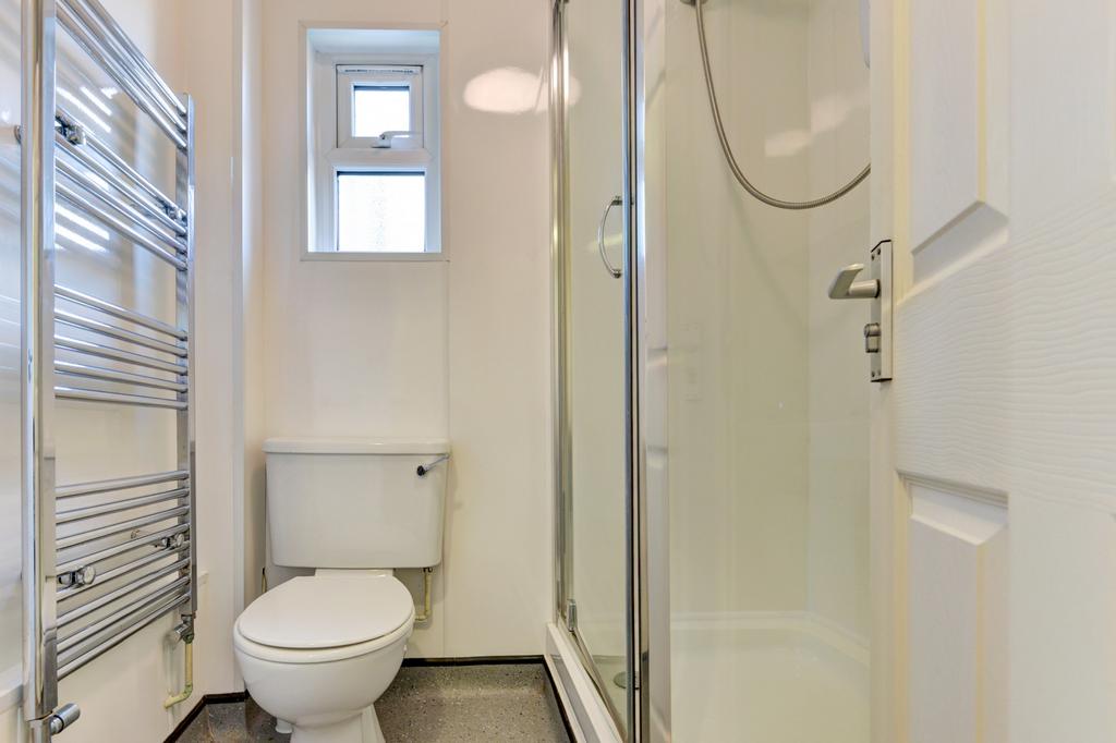 Bright and clean bathroom featuring a modern sh...