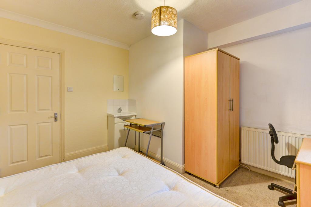 Bright, neatly presented bedroom featuring a do...