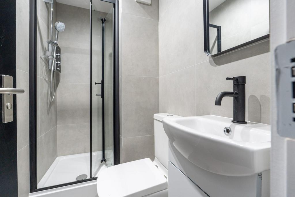 Modern, well-maintained bathroom featuring a sl...