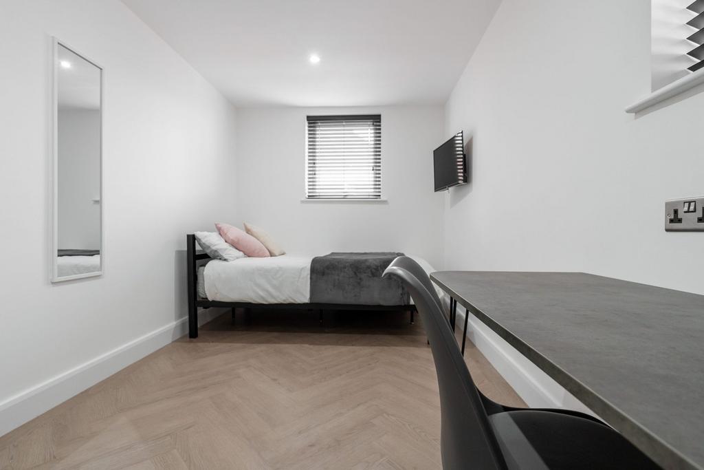 A sleek, minimalist bedroom featuring a comfort...
