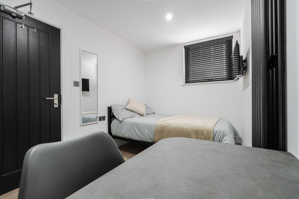 A cozy, well-maintained bedroom featuring a sin...