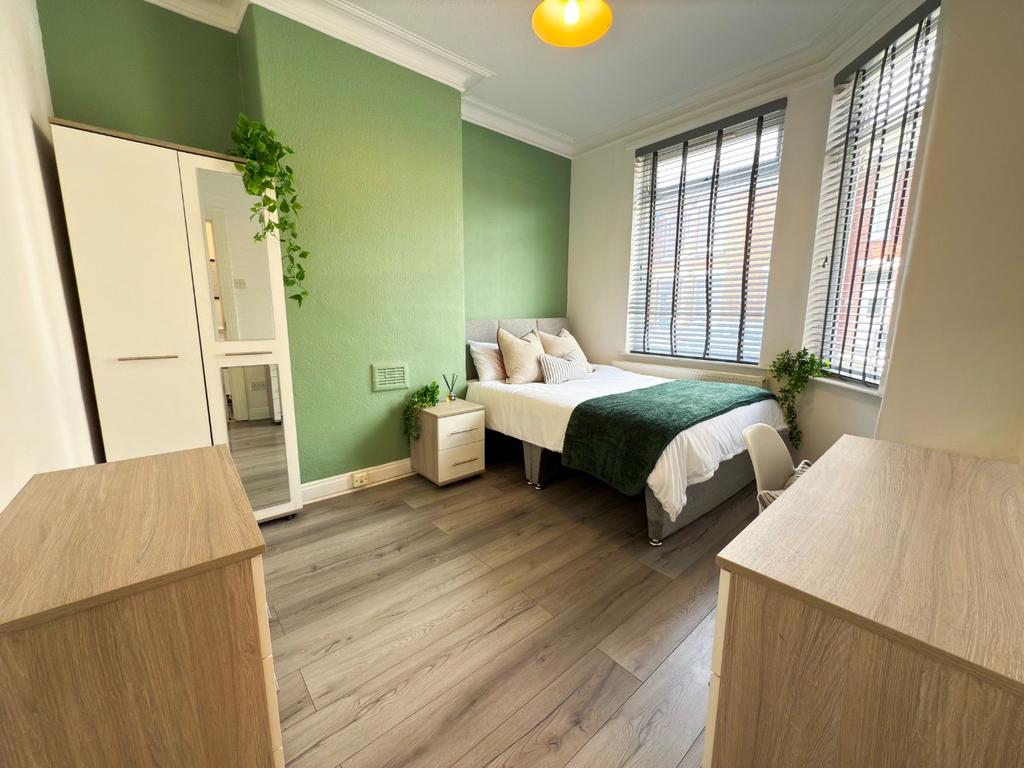Bright, modern double bedroom with a comfy doub...