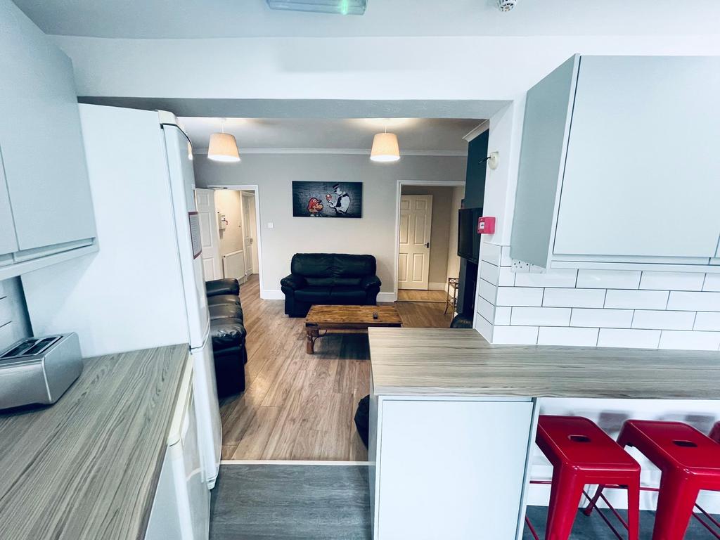 Bright, modern kitchen opening onto a comfortab...