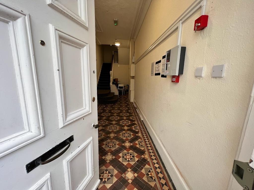 Inviting entrance hallway with decorative tiled...