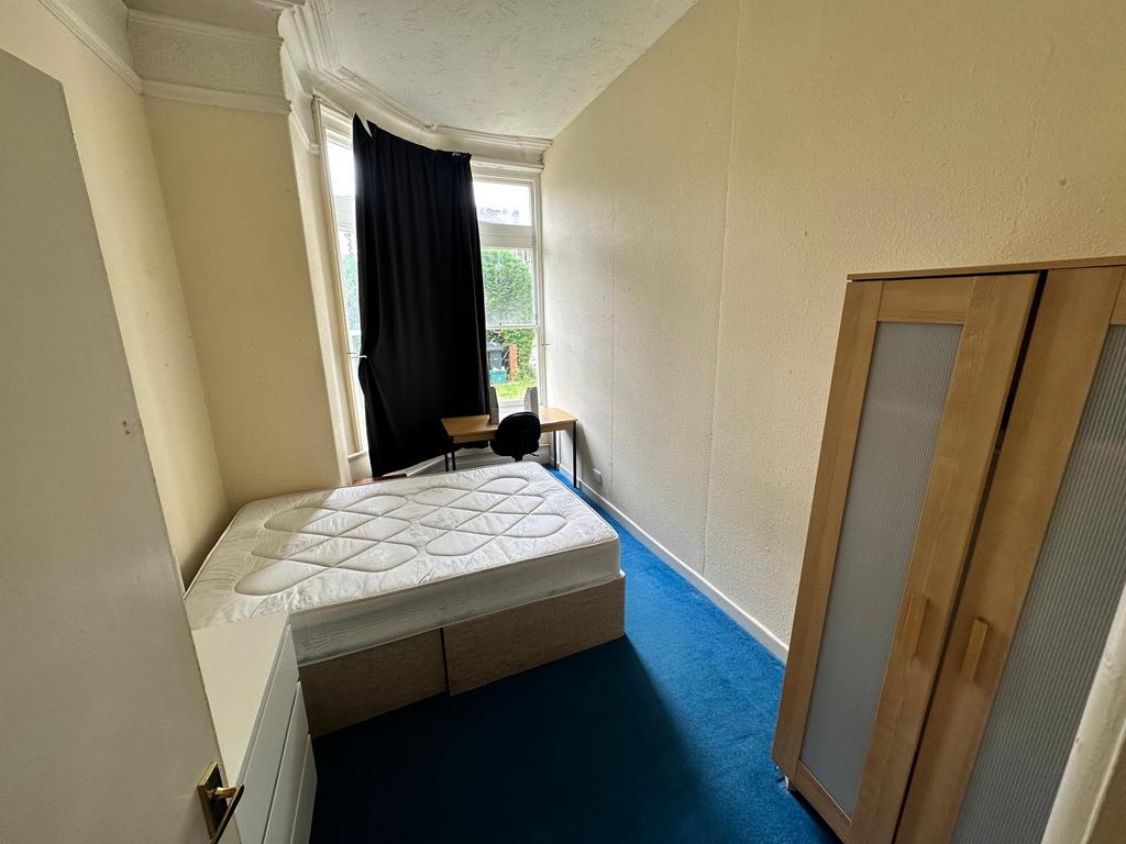 Bright bedroom with a comfortable double bed, w...