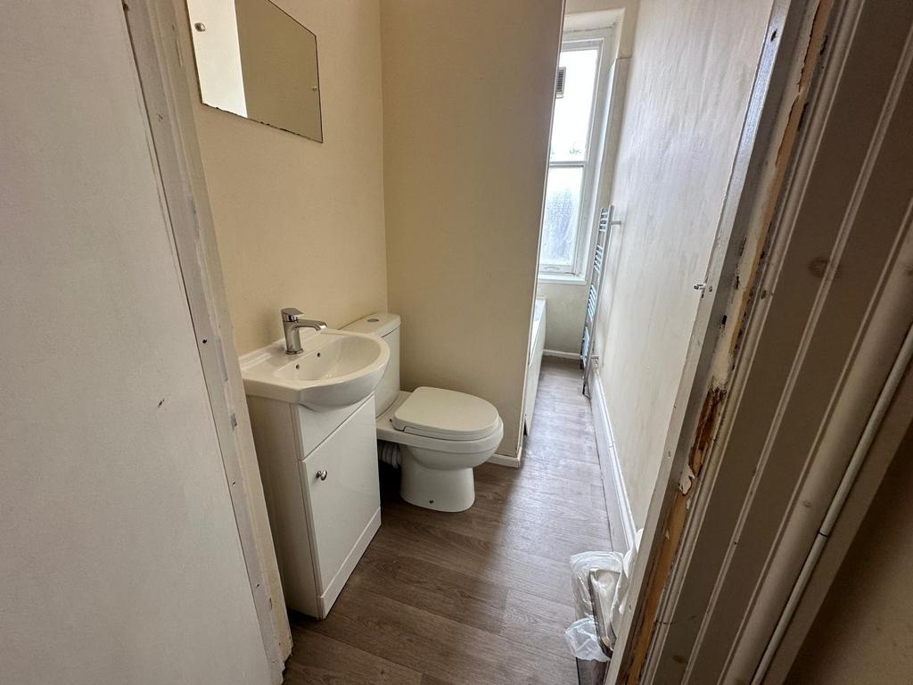 Compact bathroom with a modern sink and vanity,...