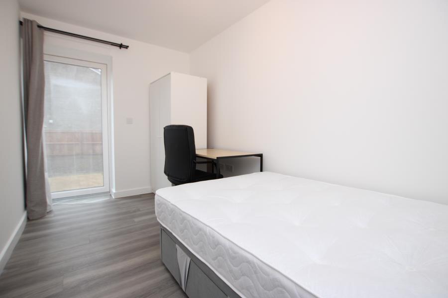 Bright, modern single bedroom with clean lines ...