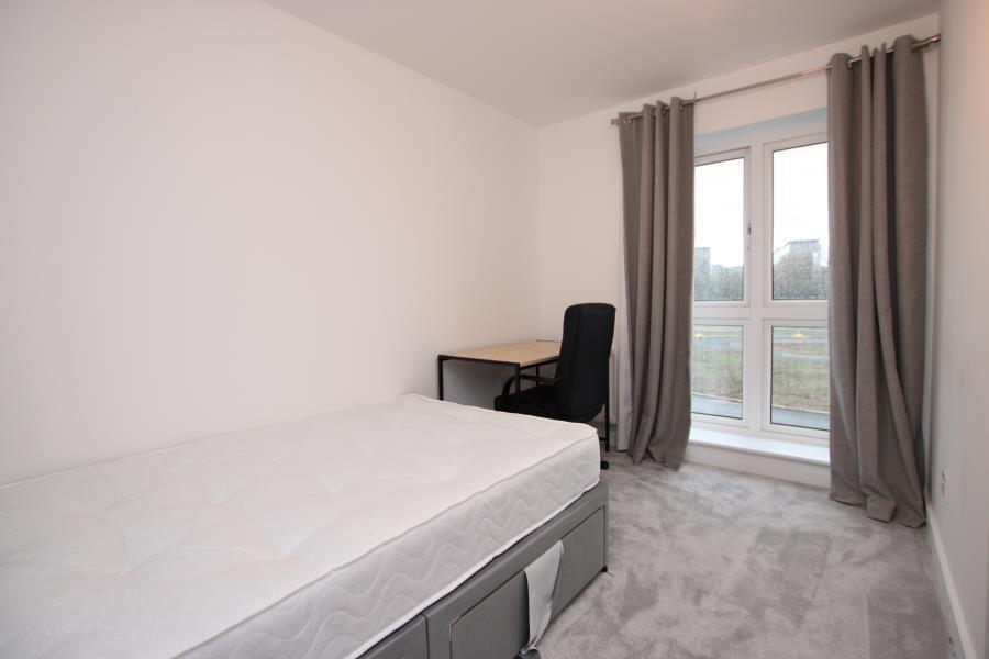 Bright, simply furnished single bedroom with a ...