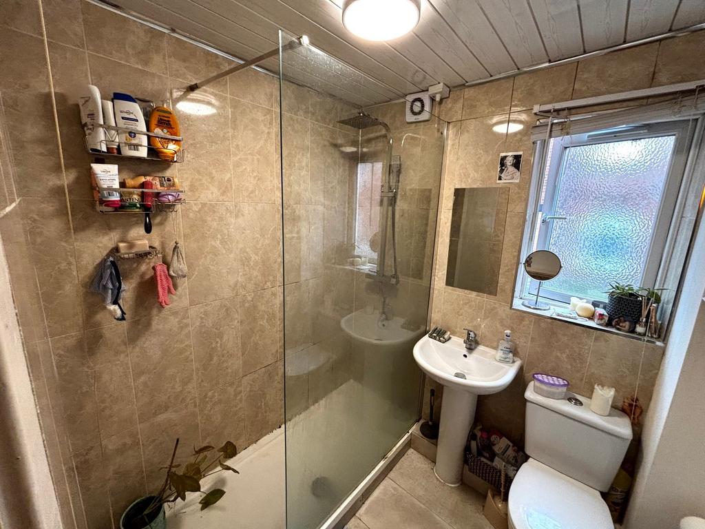 Well-equipped tiled bathroom with a walk-in sho...