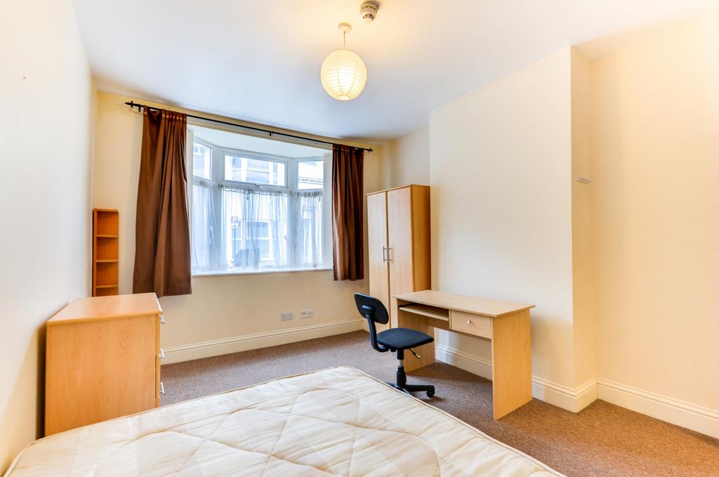 Well-lit double bedroom with a large front-faci...