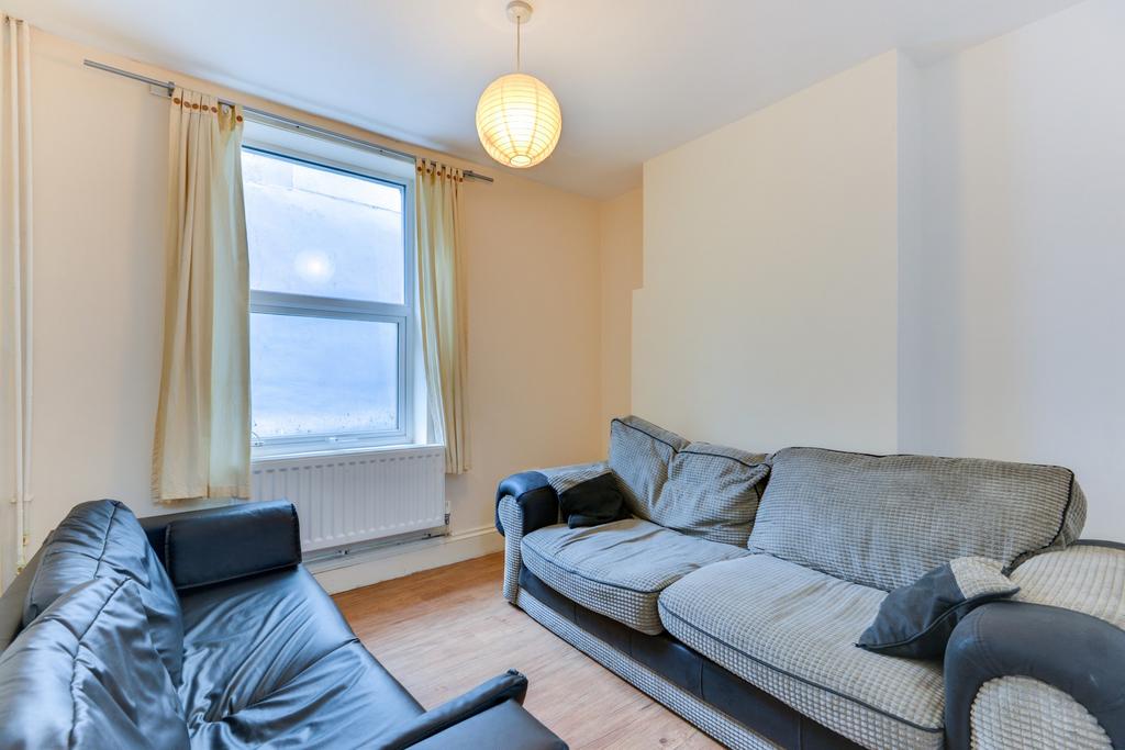 Bright, simply furnished living room with large...