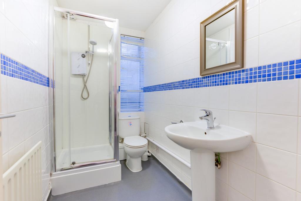 A clean and bright bathroom featuring a shower ...