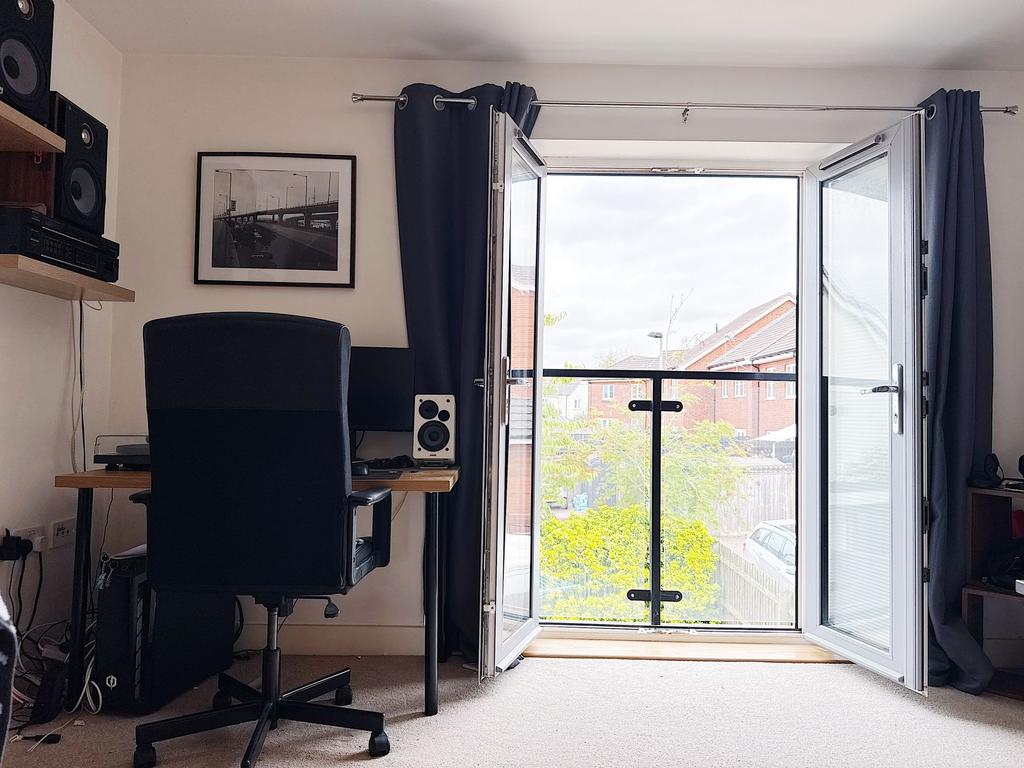 Bright upstairs bedroom with a study area besid...